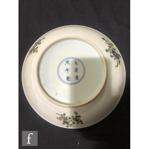 225 - A set of eight Chinese famille verte dishes, each of circular form, the shallow well of each decorat... 