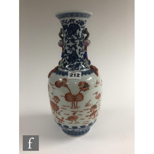 212 - A Chinese blue and white porcelain vase of bottle form applied with iron-red enamels to the central ... 