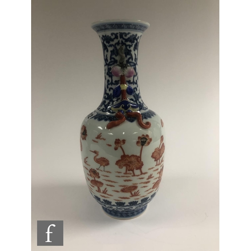 212 - A Chinese blue and white porcelain vase of bottle form applied with iron-red enamels to the central ... 