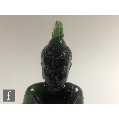 232 - A Chinese green pressed moulded glass figure of Buddha, seated in dhyanasana atop a pedestal base, h... 