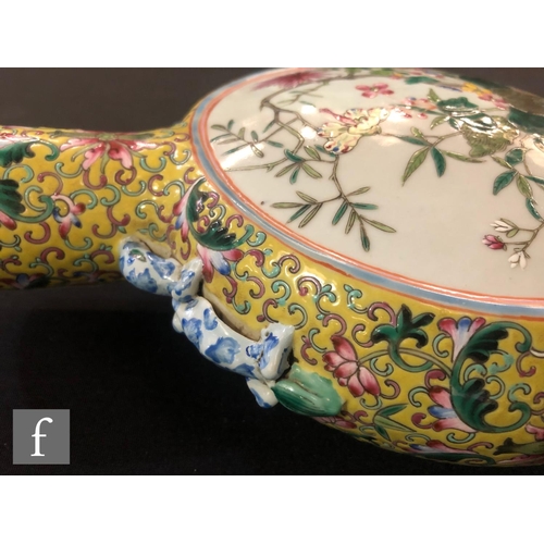 202 - A Chinese yellow ground famille rose moonflask, the porcelain flask rising from a high foot and flan... 