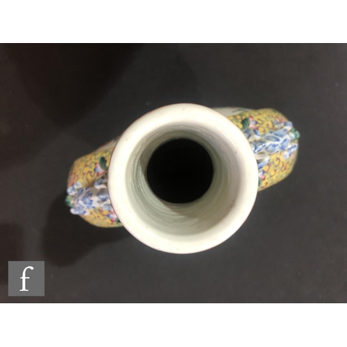 202 - A Chinese yellow ground famille rose moonflask, the porcelain flask rising from a high foot and flan... 