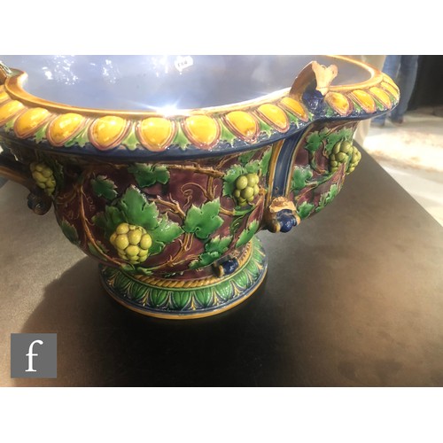 122 - A large late 19th Century majolica quatre-lobed wine cooler decorated with moulded grape vines in to... 