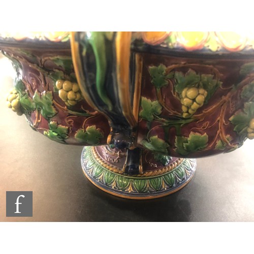 122 - A large late 19th Century majolica quatre-lobed wine cooler decorated with moulded grape vines in to... 