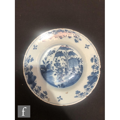 84 - Three assorted 19th Century tin glazed plates decorated in blue and white with Chinoiserie roundels,... 