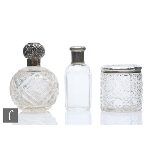 359 - A collection of silver topped glass bottles, to include a silver topped glass dressing table jar, Bi... 