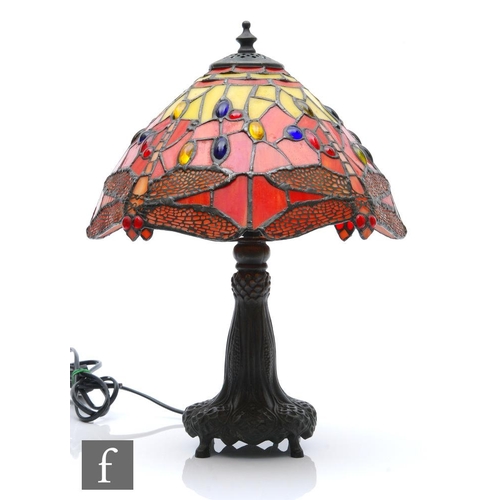 322 - A reproduction Tiffany style table lamp, the shade decorated with a mosaic dragonfly design in tones... 