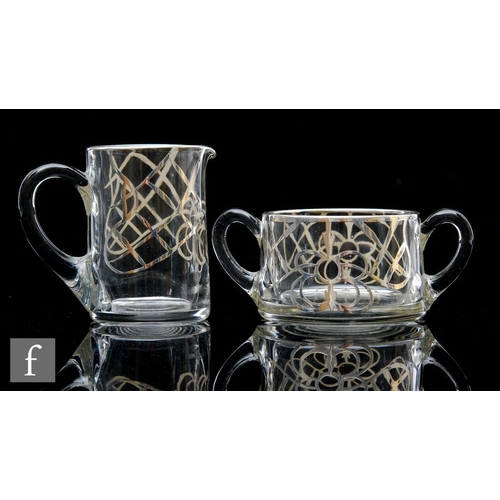 321 - A 20th Century moulded clear crystal cream jug, with applied silvered stylised floral decoration, to... 