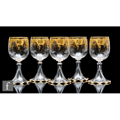 330 - A set of five early 20th Century French crystal wine glasses, possibly Saint Louis, the ovoid bowls ... 