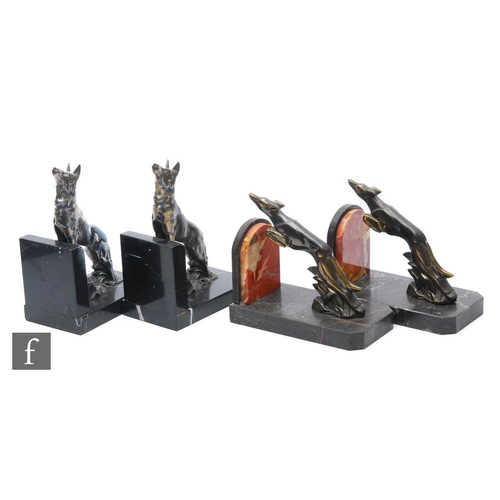 910 - A pair of 20th Century Art Deco spelter bookends, decorated with stylised silvered Alsatians perched... 