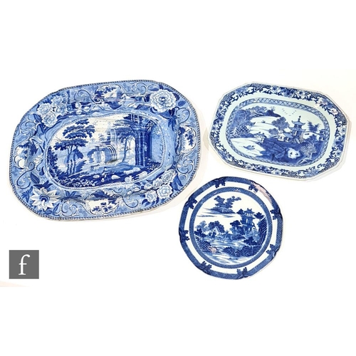 105 - A large 19th Century blue and white meat plate transfer decorated with ruins in a landscape with a f... 