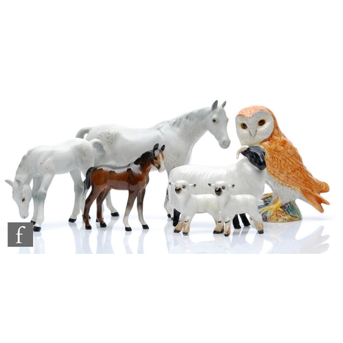 129 - Seven assorted Beswick animals to include a model 1991 mare, two model 938 lambs and a tawny owl, al... 