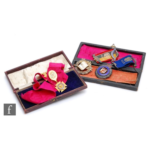 827 - Three 1920s Buffalo jewels to include two silver examples and gilt metal example to a red silk ribbo... 