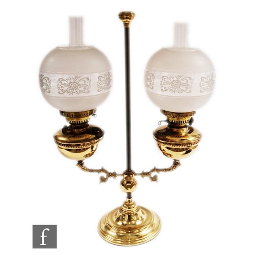 831 - A 1970s twin branch brass oil lamp with beaded edge reservoirs on a circular base, acid etched shade... 