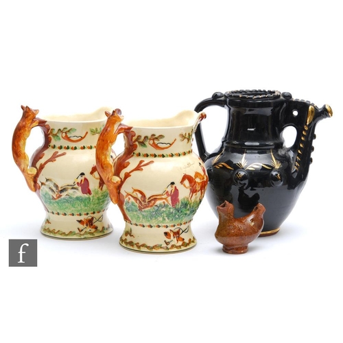 833 - Two Crown Devon Fieldings John Peel musical jugs, a black glazed terracotta puzzle jug and a 19th ce... 