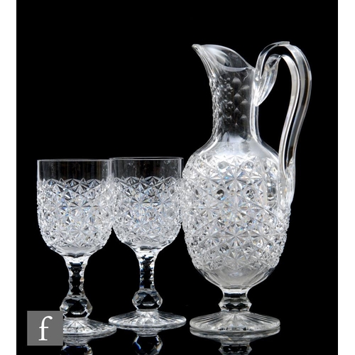 340 - A late 19th Century clear crystal hobnail and star cut glass footed jug with applied loop handle, pr... 