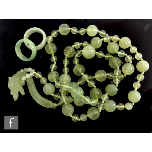 439 - A Chinese green glass faux jade bead necklace, the knotted beads with twenty five large beads, space... 