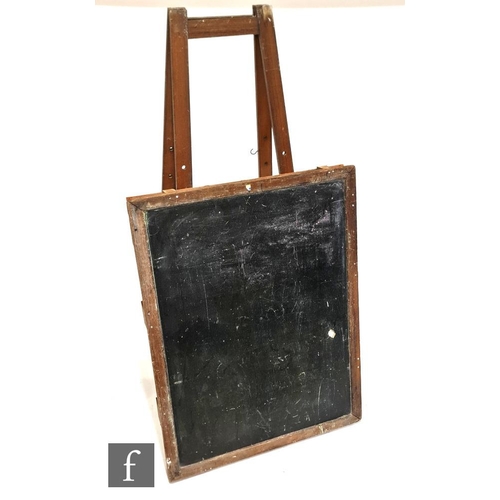 1128 - An early 20th Century schoolroom blackboard on easel stand, easel height 178cm, blackboard 121cm x 9... 