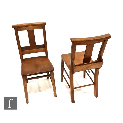 1129 - A set of six early 20th Century chapel chairs, each with a prayer book shelf to the rear and saddle ... 