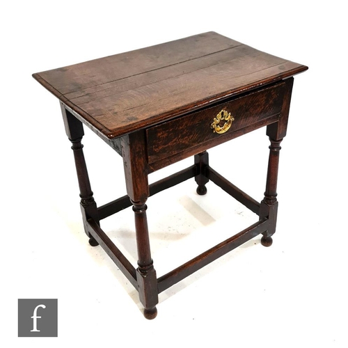 1132 - An 18th Century oak side table, the rectangular top with moulded edge above a single frieze drawer a... 