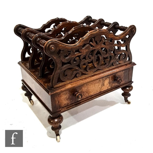 1139 - A Victorian walnut three-division Canterbury, with fret-cut divisions over a single frieze drawer, h... 