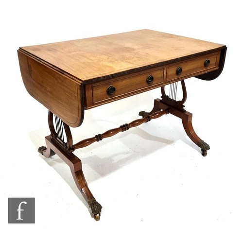 1140 - A 19th Century line inlaid mahogany sofa table raised to lyre-shaped supports united by a turned str... 