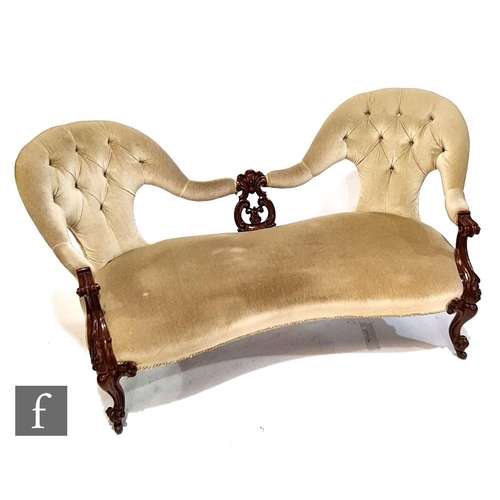 1142 - A Victorian twin-ended spoon-back settee, with pierced central splat and with carved scroll capitals... 