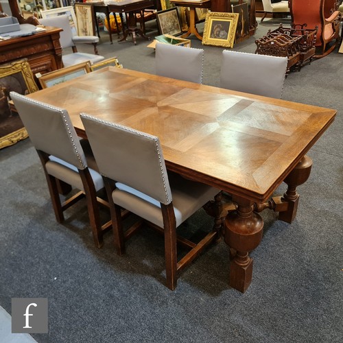 1134 - An early 20th Century oak draw-leaf refectory style dining table with marquetry top, raised to four ... 