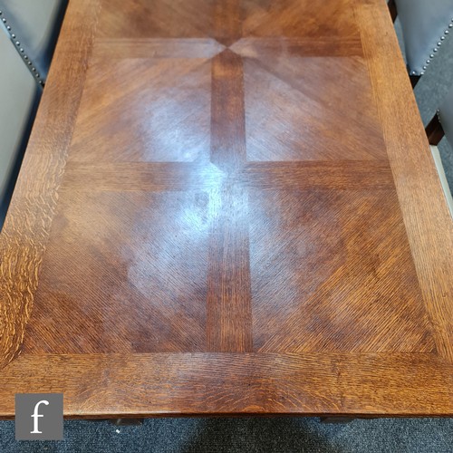 1134 - An early 20th Century oak draw-leaf refectory style dining table with marquetry top, raised to four ... 