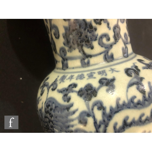 171 - A collection of Chinese blue and white vases, to include a Gu vase with phoenix, height 31cm, a face... 