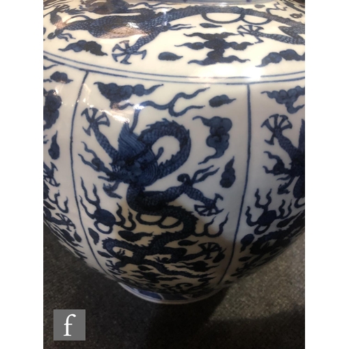 179 - A large Chinese blue and white vase of rounded ovoid form, rising from a spreading circular footring... 