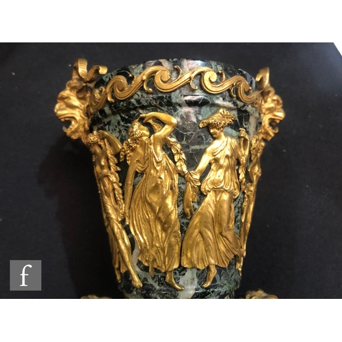 882 - A pair of late 19th Century French ormolu mounted variegated marble urns, detailed with cherubs and ... 