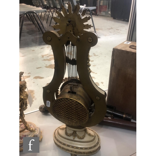 883 - A late 19th Century French lyre shaped Marie Antoinette mantel clock with eight-day movement strikin... 