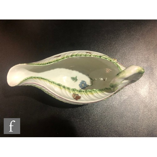 68 - An 18th Century Worcester Cos Lettuce shape sauce boat, the moulded body sparsely decorated with han... 