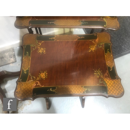 1150 - A nest of three early 20th Century mahogany occasional tables, decorated with floral panels within t... 