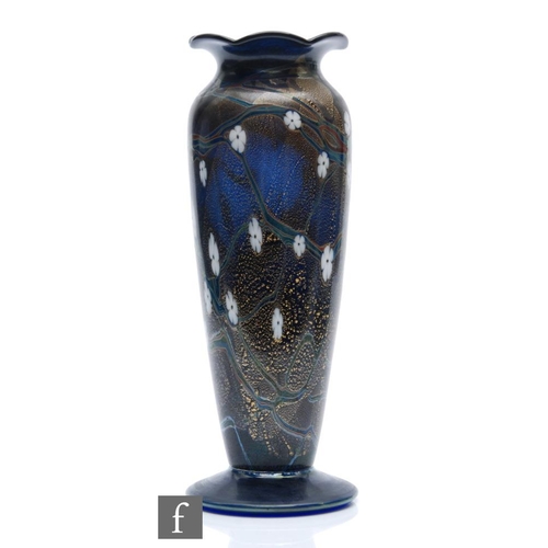 1136 - Okra - A later 20th Century studio glass vase in the Charlock pattern, of footed form with wave rim,... 