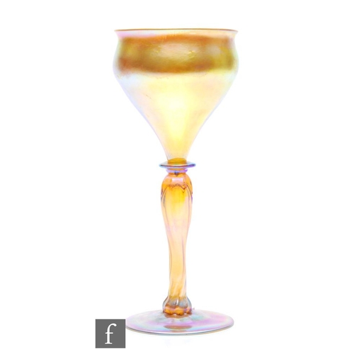 28 - Louis Comfort Tiffany - An early 20th Century drinking glass with ogee bowl with basal bladed knop o... 