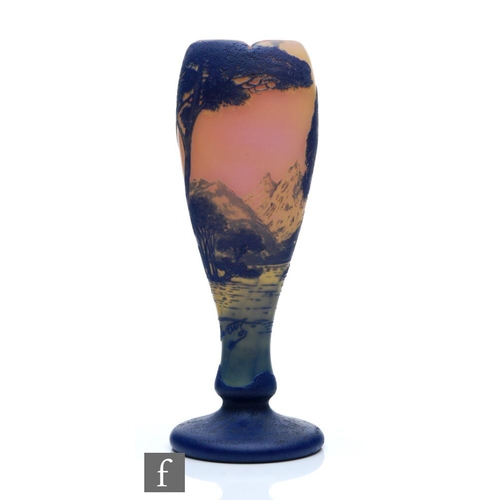 53 - Devez - An early 20th Century cameo glass vase of footed swollen form, cased in blue over peach and ... 