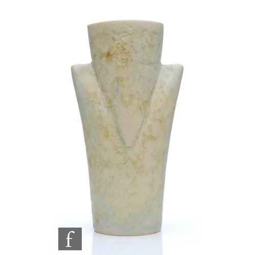 1186 - Chris Carter - A studio pottery vessel of triangular shaped form glazed in a pale oatmeal, seal mark... 