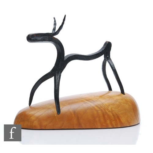 1190 - Unknown - A 20th Century hand wrought iron figure of a stylised deer raised to a domed wooden base, ... 