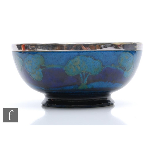 145 - William Moorcroft - A high sided bowl decorated in the Moonlit Blue pattern with trees to the interi... 