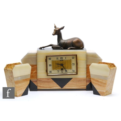 574 - Unknown - A 1930s French Art Deco three piece onyx and marble clock garniture, the clock surmounted ... 