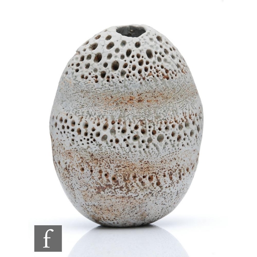 718 - Alan Wallwork - A studio pottery seed form of compressed oval section with incised and stippled deco... 