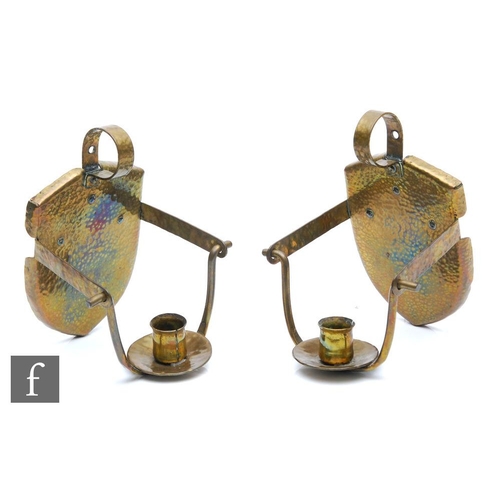 95 - Unknown - A pair of Arts and Crafts style candle stick wall sconce each with a shield shaped back, l... 