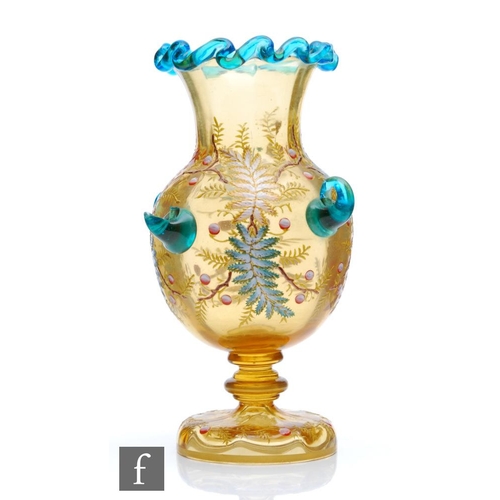 35 - Harrach - A late 19th Century continental amber glass vase of footed ovoid form with flared collar n... 