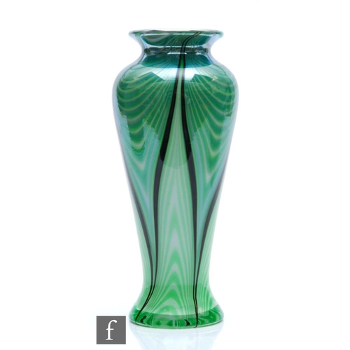 1135 - Okra - A contemporary studio glass vase of slender baluster form, the opal core cased in a graduated... 