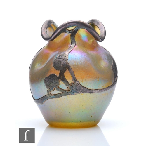 34 - Loetz - An early 20th Century glass vase of dimpled shouldered ovoid form with an everted and folded... 