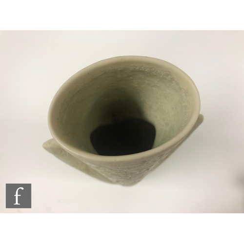 1186 - Chris Carter - A studio pottery vessel of triangular shaped form glazed in a pale oatmeal, seal mark... 