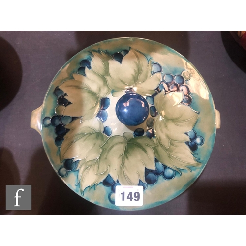 149 - William Moorcroft - A large shallow bowl and cover decorated in the salt glazed Leaf and Berry patte... 