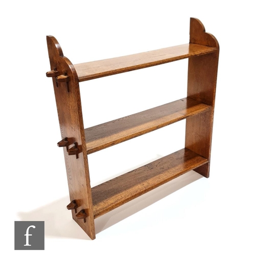 100 - Unknown - An oak open fronted three tier bookcase with exposed tenon joints in the Arts and Crafts s... 